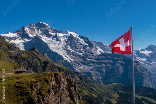 Spectacular view on famous Jungfrau from Mannlichen and swiss flag