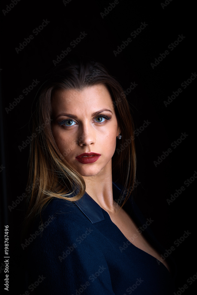 Fototapeta premium Sexy young blonde with red lips on a black background