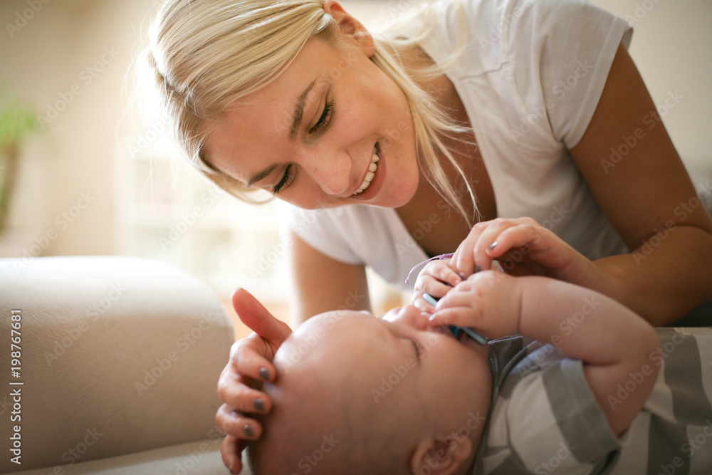 Mother caresses and tears her crying baby. Close up. Mother caresses and tears her crying baby. Close up.