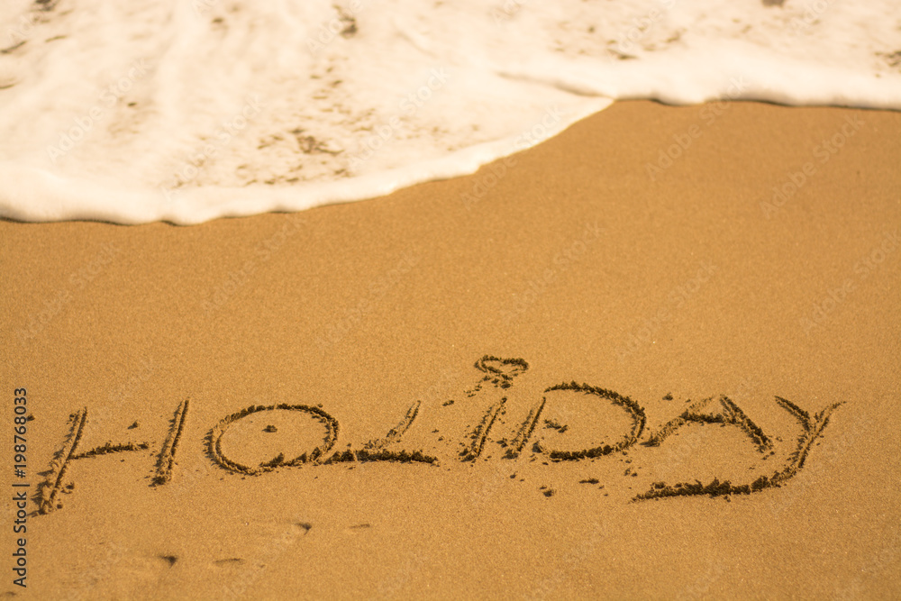  holiday writing concept on sand