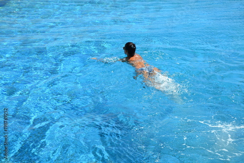 A young girl swims in the pool