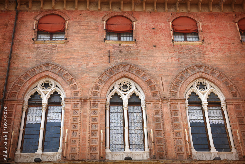 Front view of old building with decorated windows. Bologna, Italy