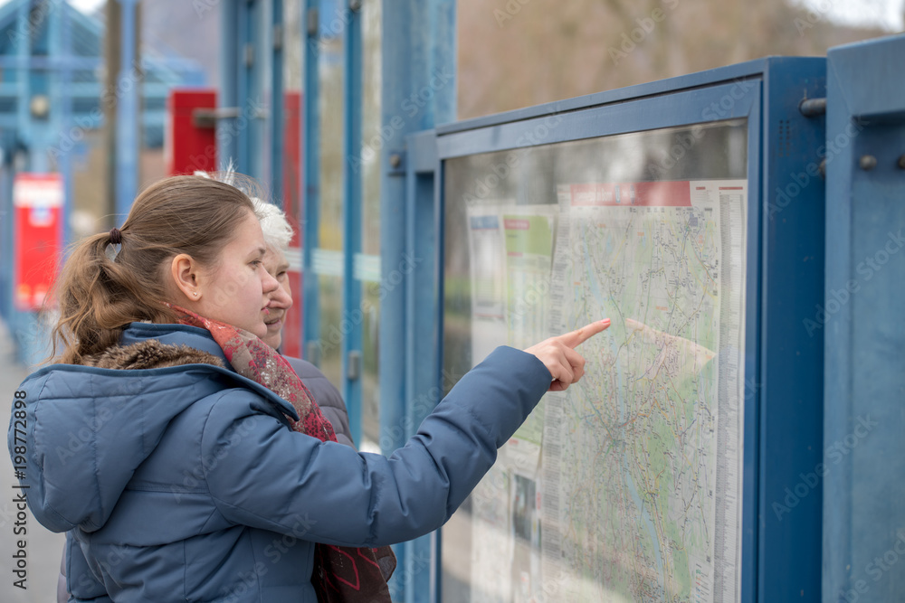 two women look at the map