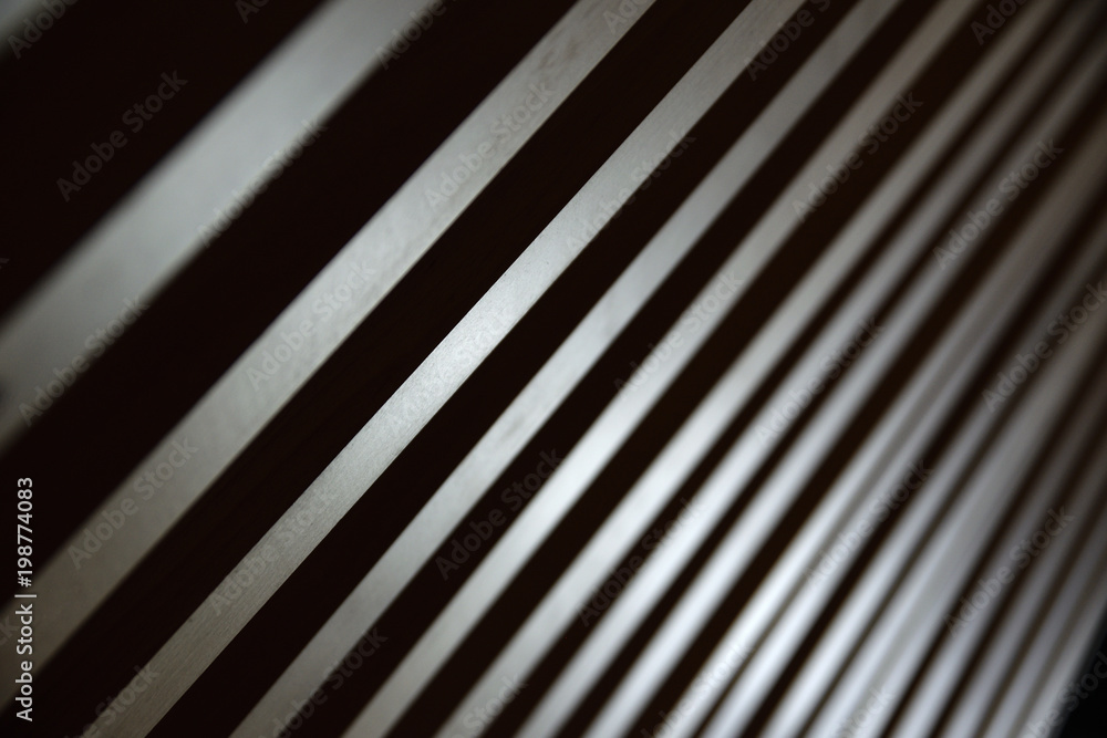 Fototapeta premium Some parallel lines creating a diagonal background. Low key backdrop.