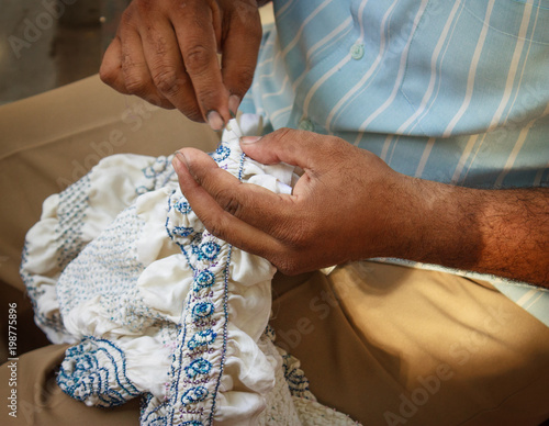 Bandhani fabric being tied into small knots to be prepared for dyeing. Gujarat, India