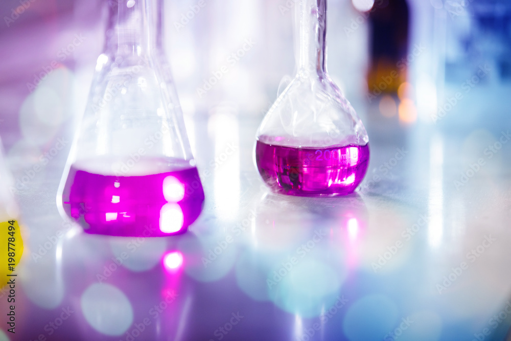 Laboratory glassware with pink liquids and white smoke Laboratory glassware with pink liquids and white smoke