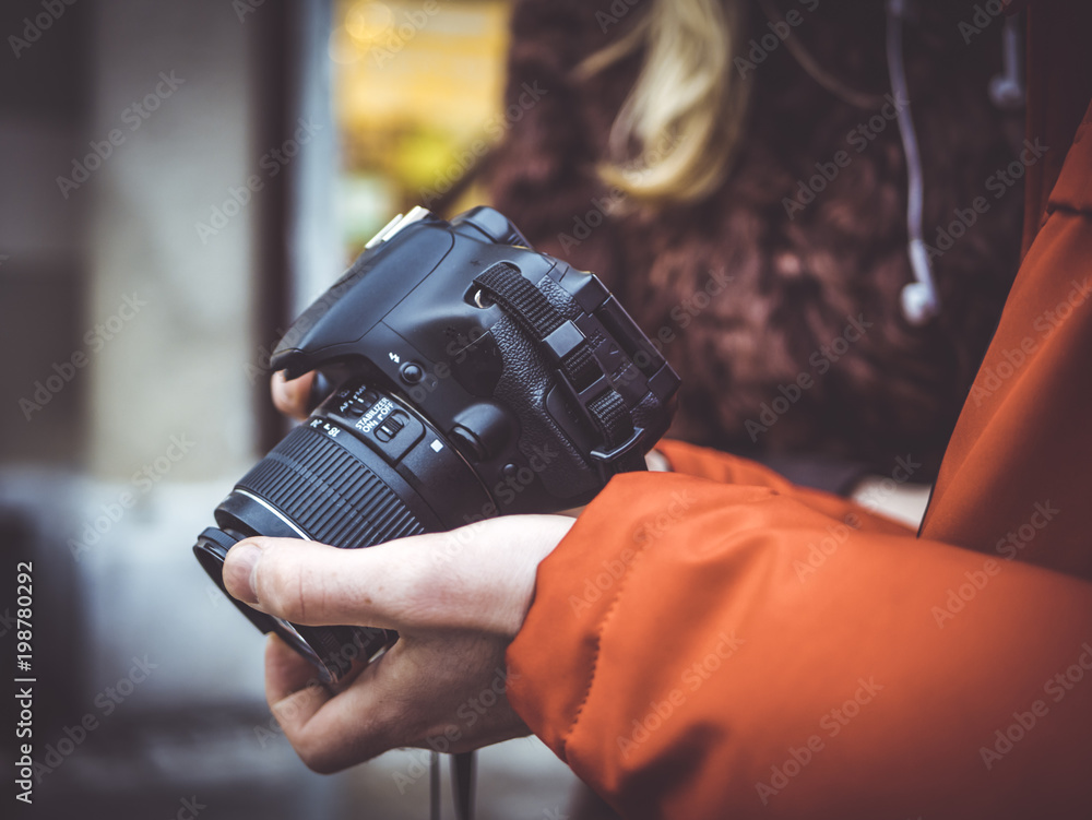 close up portrait of man holding dslr camera in his hands