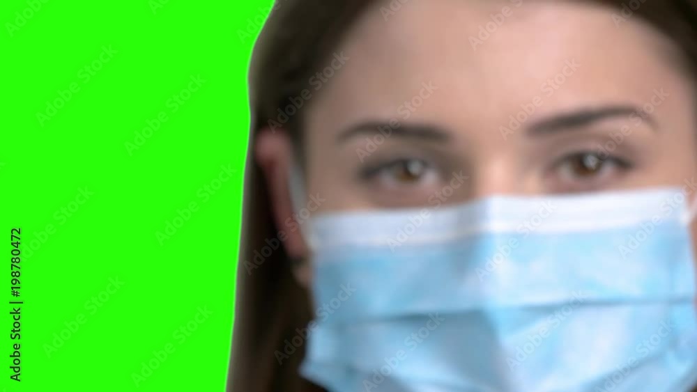 Close up focused syringe. Blurred young female doctor face. Green screen hromakey background for keying. Close up focused syringe. Blurred young female doctor face. Green screen hromakey background for keying.