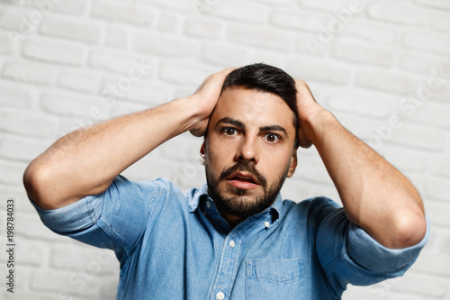 Facial Expressions Of Young Beard Man On Brick Wall