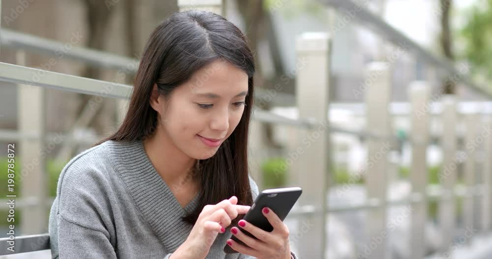 Woman use of cellphone at outdoor Woman use of cellphone at outdoor
