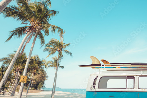 Photography vintage car parked on the tropical beach (seaside) with a surfboard on the roof - Leisure trip in the summer