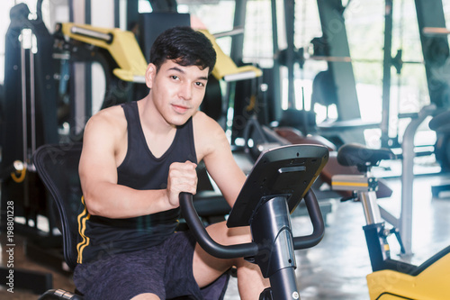 Fitness man execute exercise with exercise-machine at the gym