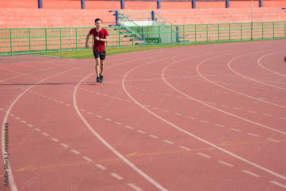 Young asian sporty man running in sport complex center Young asian sporty man running in sport complex center