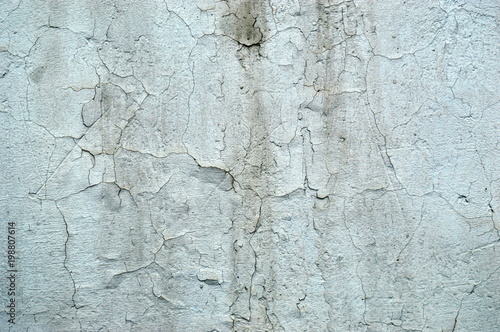 An old dirty wall with cracked paint.