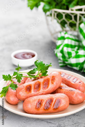 Grilled sausages on plate. BBQ sausages.