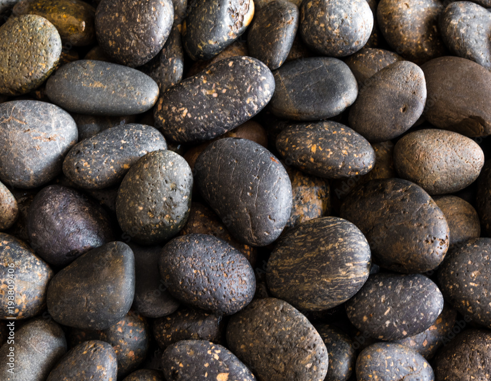 Texture of dried round gray river stone background Texture of dried round gray river stone background