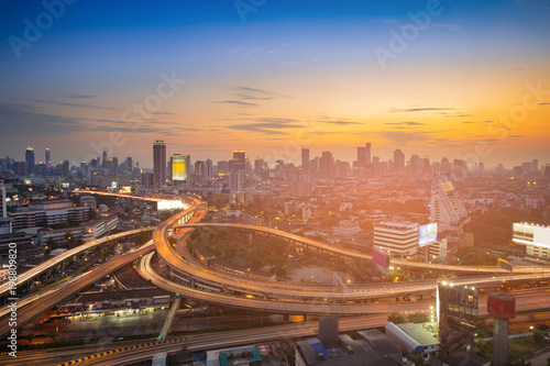 Sunset sky over city business downtown and highway intersection, cityscape background