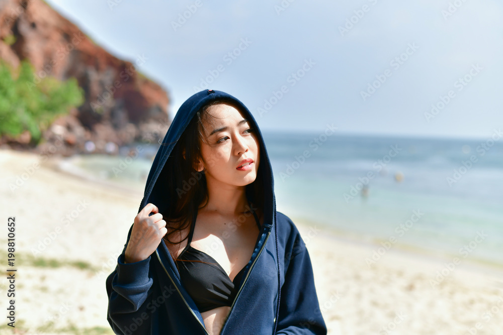 Sexy girl concept in swimsuit. Beautiful woman wearing a swimsuit playing in the beach. Girl in sexy swimsuit poses seductively. Sexy girl seduces a young man on the beach. Sexy girl concept in swimsuit. Beautiful woman wearing a swimsuit playing in the beach. Girl in sexy swimsuit poses seductively. Sexy girl seduces a young man on the beach.