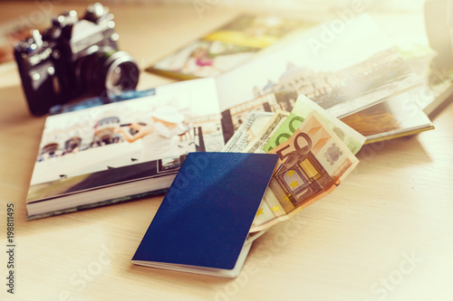 Old Album with photos of travel and vintage camera on wooden background