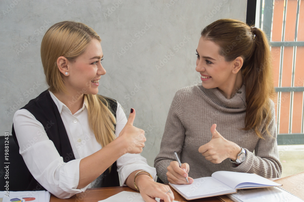 Business Concepts, Young business woman is meeting in office. Young businesswoman is working happily. Businesswomen work as a team for success. Business people work with smiles. Business Concepts, Young business woman is meeting in office. Young businesswoman is working happily. Businesswomen work as a team for success. Business people work with smiles.