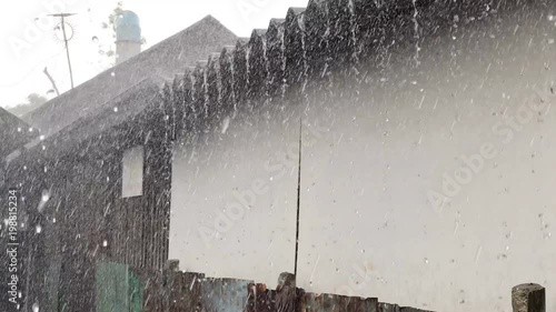 Heavy rain fell on the roof of the house.