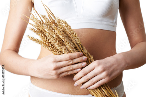 Close Up Of Woman Wearing Underwear Holding Bundle Of Wheat