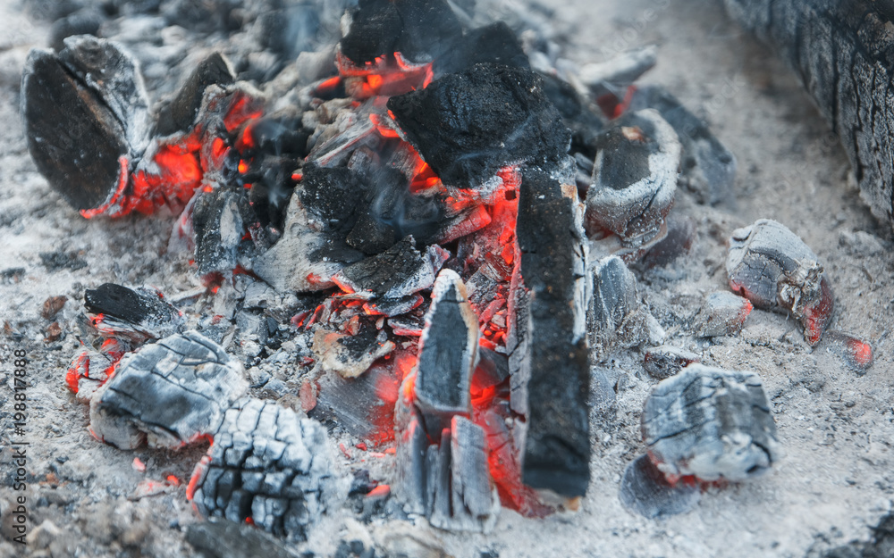 Heat from burnt wood logs in the campfire on a picnic. Heat from burnt wood logs in the campfire on a picnic.