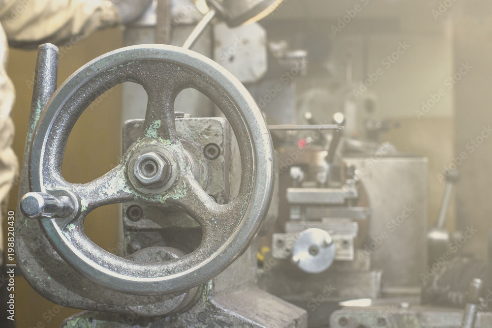 working man working on an old lathe working man working on an old lathe