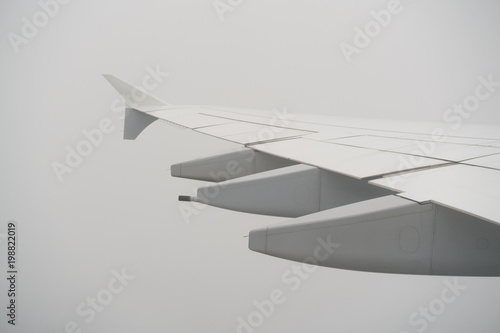 airplane wing during flight in heavy clouds