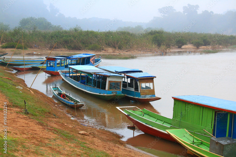 Long Tail wooden boat beside the river at Luangprabang, Laos