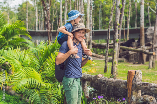 Father and son at the zoo. Spending day with family at the zoo photo