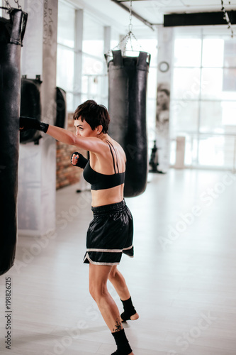 vertical side view image of fit female participating in boxing sport event. get training. © alfa27