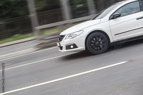Fast moving car on  blurred background. © Yuri Bizgaimer