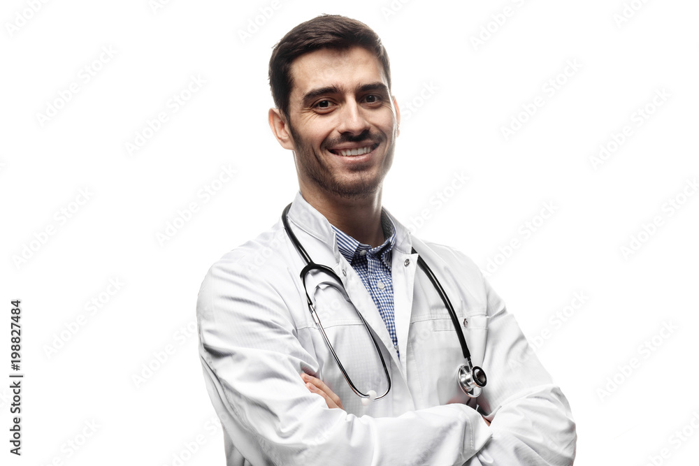 Smiling man doctor posing with arms crossed, wearing a stethoscope, isolated on white background