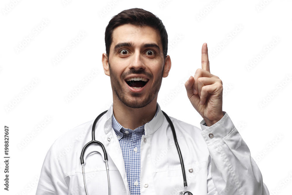 I have an idea! Man doctor keeping finger pointed upwards, showing something above his head, making gesture with index finger I have an idea! Man doctor keeping finger pointed upwards, showing something above his head, making gesture with index finger