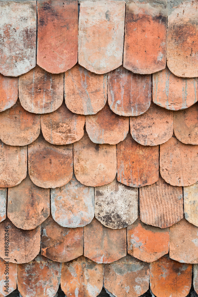 Close-up of old and weathered red roof tiles texture background. Close-up of old and weathered red roof tiles texture background.