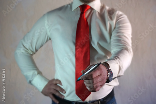 A respectable man in a business style in a white shirt with a red tie and large hands on a white background.