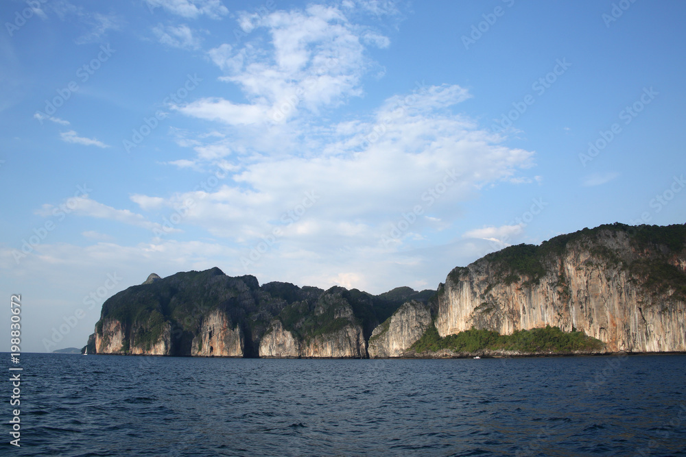 Rugged cliff lined coastline of Koh Phi Phi from the sea, Krabi province, Thailand. Rugged cliff lined coastline of Koh Phi Phi from the sea, Krabi province, Thailand.