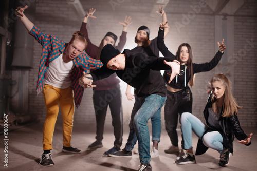 group of rappers showing gestures calling to compete with them on dancing and singing. sending a challenge photo