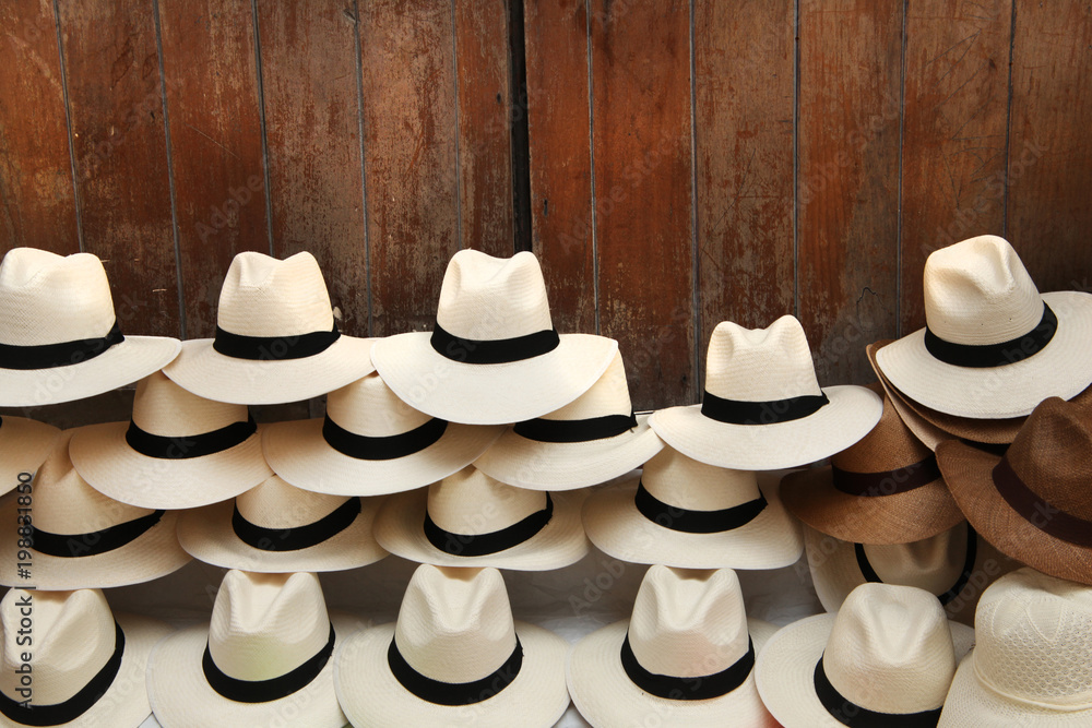 A selection of Panama hats piled up against a wooden door, Cartagena, Colombia.