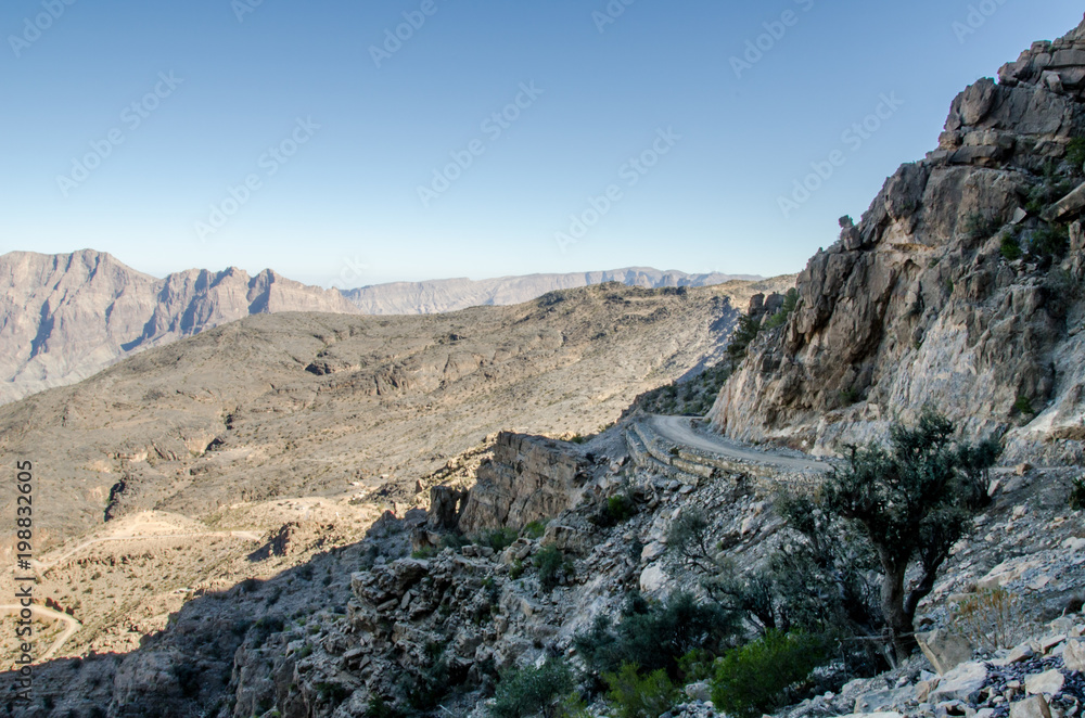 Windy gravel road through mountains im Oman