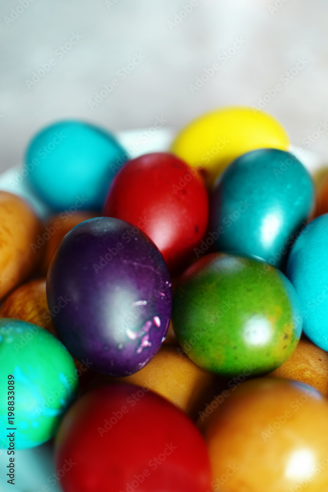 Colorful boiled Easter eggs in white plate on grey background. Colorful boiled Easter eggs in white plate on grey background.