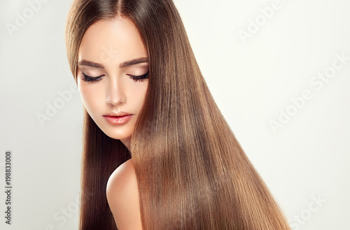Beautiful model girl with shiny blonde straight long hair . Care and hair products . 