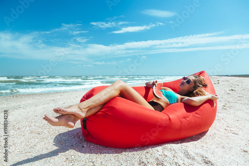 Girl relaxing on lamzac on the beach