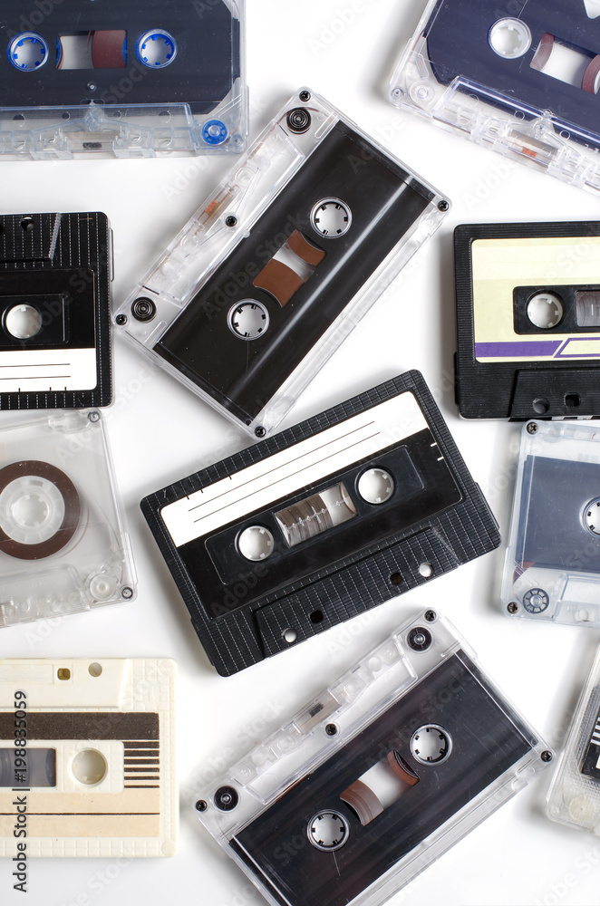 Fototapeta premium Old audio cassettes on white background. Flat top view