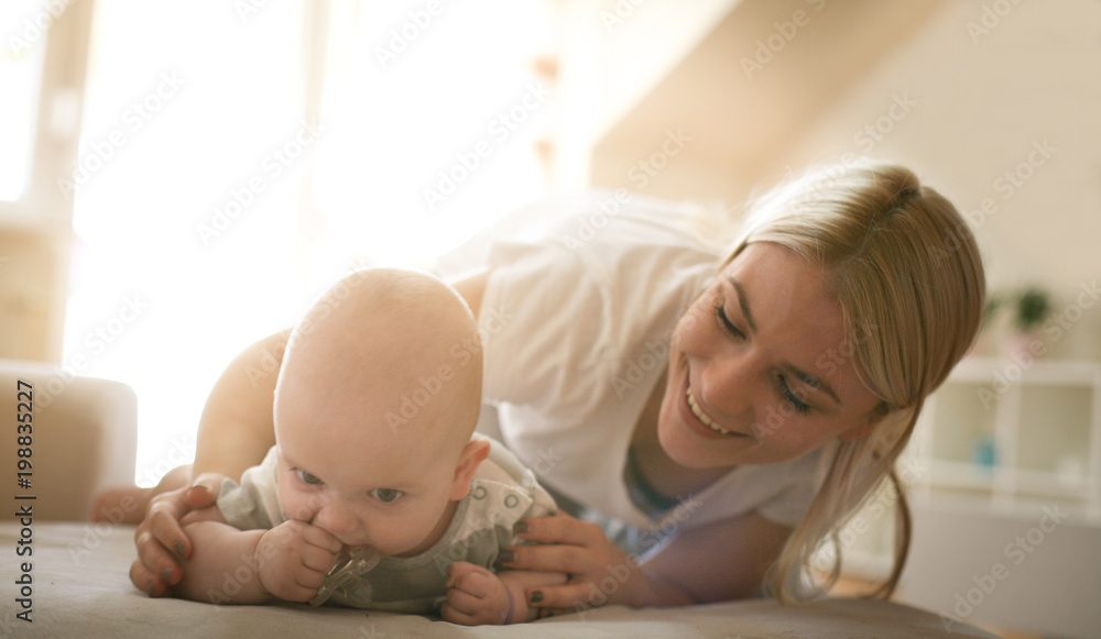 Mother on bed with her baby boy. Mother on bed with her baby boy.