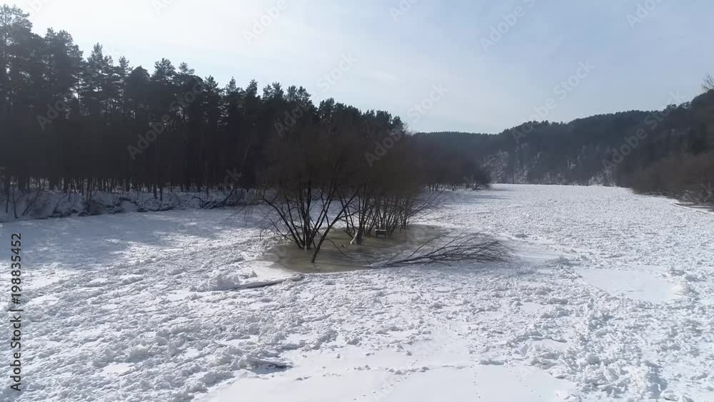 Island on frozen River, aerial winter landscape Island on frozen River, aerial winter landscape