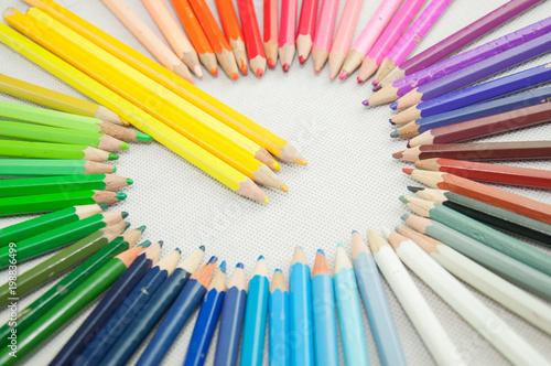 wooden colored pencils on white texture