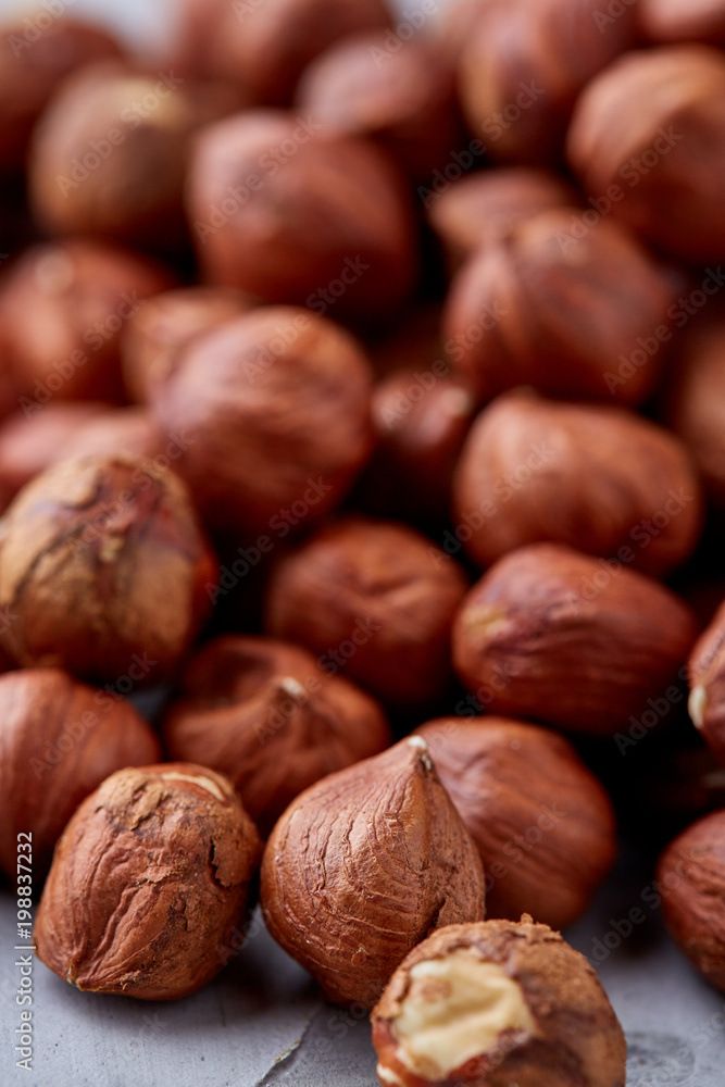 Raw hazelnut on heap isolated on white background, selective focus, shallow depth of field Raw hazelnut on heap isolated on white background, selective focus, shallow depth of field