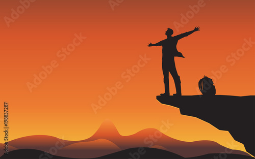 Sillhouette man on mountain cliff